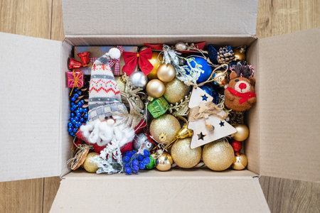 Christmas ornaments in a box on wooden background. Top viewの写真素材