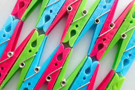 Colorful clothespins on a white background, close-up.の写真素材