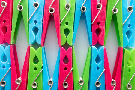 Colorful clothespins on a white background, close-up.の写真素材
