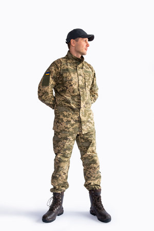 Full body soldier in military uniform looking away on white background.の写真素材
