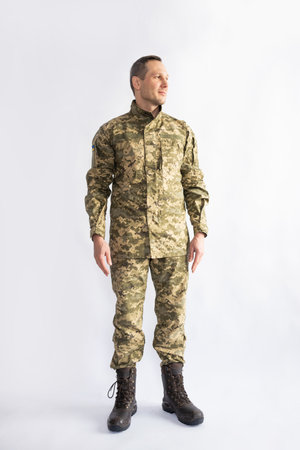 Full length portrait of a young soldier in camouflage clothing on white backgroundの写真素材