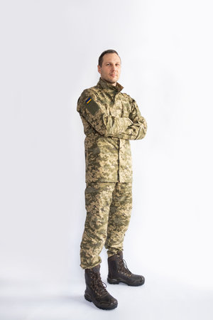 Full length portrait of a soldier in camouflage uniform isolated on white backgroundの写真素材
