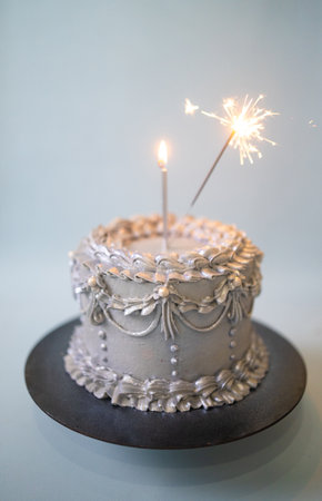 Birthday cake with sparklers on gray background. Shallow dof.の写真素材
