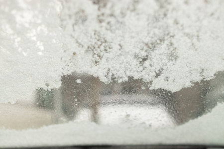 Snow on the windshield of a car in winter, close-upの写真素材