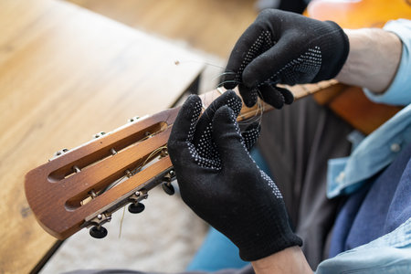 Restring classical guitar concept. Closeup at the new strings.