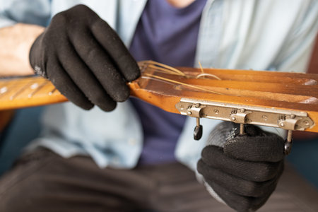 Selective focus to broken guitar with screwdriver to repairing guitar in guitar repair shop. Repair...