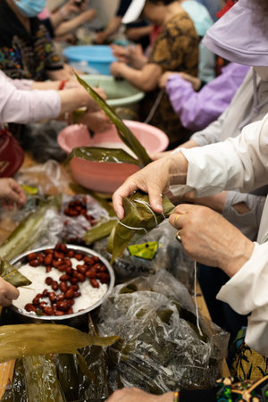 Group of Chinese woman is making zongzi by hand. Zongzi is a traditional Chinese snack.の写真素材