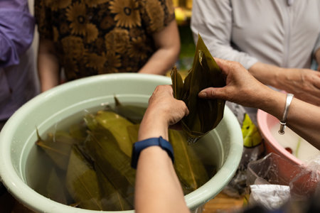 Group of Chinese woman is making zongzi by hand. Zongzi is a traditional Chinese snack.の写真素材