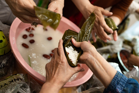 Group of Chinese woman is making zongzi by hand. Zongzi is a traditional Chinese snack.の写真素材
