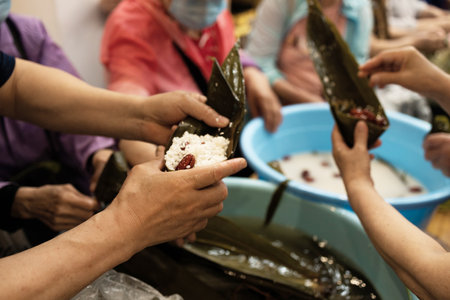 Group of Chinese woman is making zongzi by hand. Zongzi is a traditional Chinese snack.の写真素材