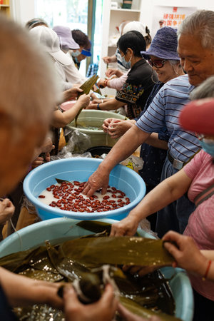 Group of Chinese woman is making zongzi by hand. Zongzi is a traditional Chinese snack.の写真素材