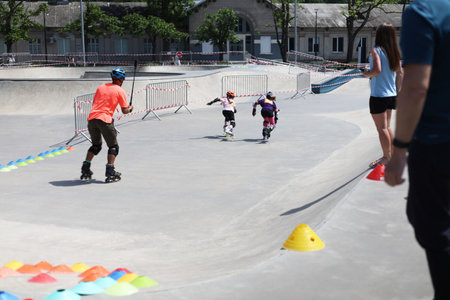 Unidentified children roller skating in skate park.