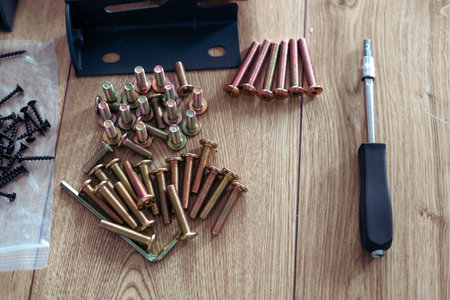 Screwdriver and screws on the wooden floor. Repair concept.の写真素材
