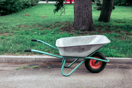 Garden wheelbarrow on the road in the park. Toned.の写真素材