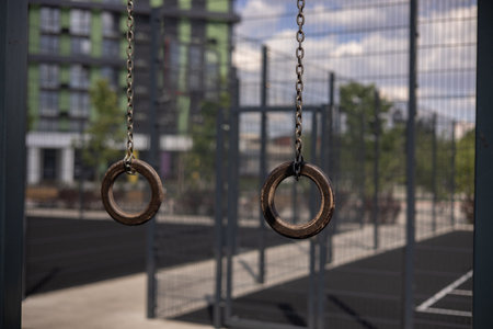 Gymnastic rings, gym and workout for aerobics, fitness and strong or power challenge for training. Equipment, tool and flexibility exercise or sports for wellness.の写真素材