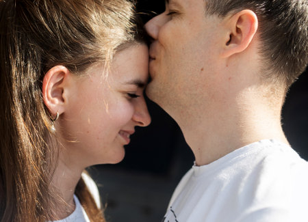 Couple in love kissing at sunset - Boyfriend and girlfriend hugging outside - Two lovers having romantic date - Love backgrounds concept.の写真素材