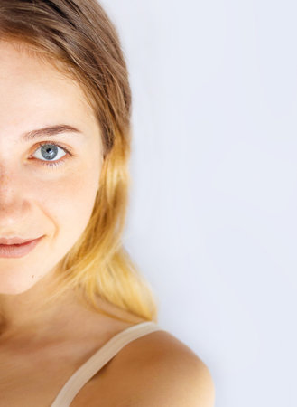 Aesthetic beauty half face portrait of blonde girl with Natural Makeup isolated on white background.の写真素材