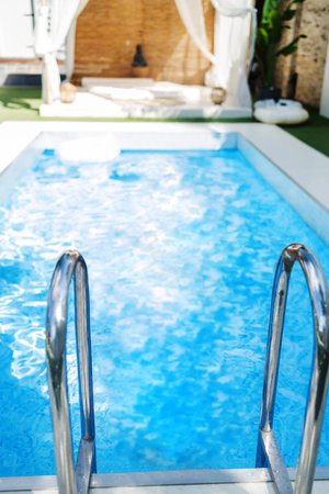 Swimming pool with ladder in luxury villa. Summer vacation conceptの写真素材