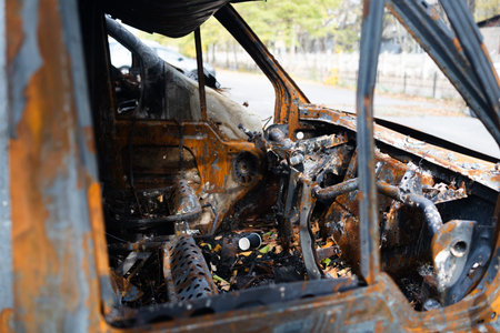 Burnt car after a road accident, close-up view of the engineの写真素材