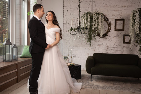 Wedding couple in love, bride and groom posing in studioの写真素材