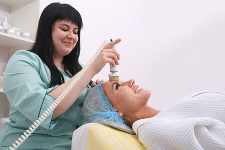 Hardware cosmetology. Beautician performs a mechanical procedure of surface peeling. Brush skin...