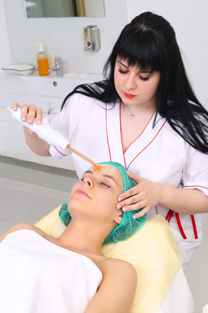 People, beauty, spa, cosmetology and technology concept - close up of beautiful young woman lying...