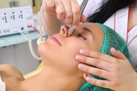 Procedure of Microdermabrasion. Mechanical Exfoliation, diamond polishing. Model, close-up. Cosmetological clinic. Medical equipment. Healthcare clinic cosmetologyの写真素材