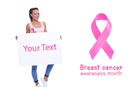 healthcare, people and medicine concept - close up of smiling women in shirts with pink breast cancer awareness ribbons and blank white board over white backgroundの写真素材