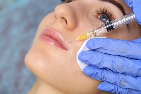 Beautiful girl on rejuvenation procedure in beauty clinic filler injection.の写真素材