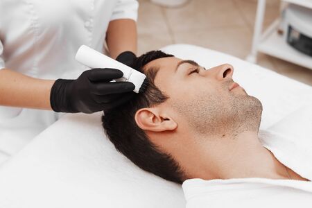 Face microneedling treatment with a meso roller.の写真素材