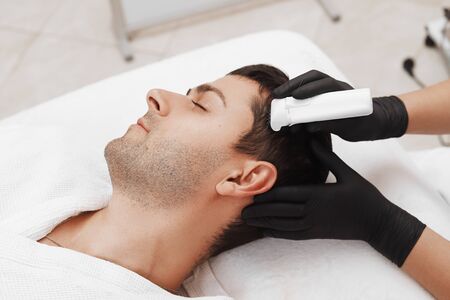 Face microneedling treatment with a meso roller.の写真素材