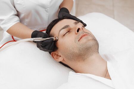 The cosmetologist makes the procedure Microdermabrasionの写真素材