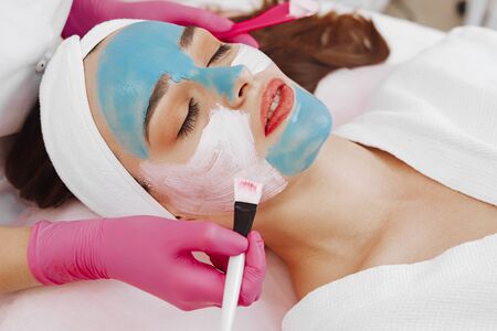 Spa Woman applying Facial cleansing Mask.の写真素材