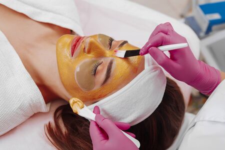 Spa Woman applying Facial cleansing Mask.の写真素材