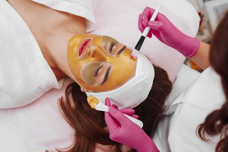 Spa Woman applying Facial cleansing Mask.の写真素材