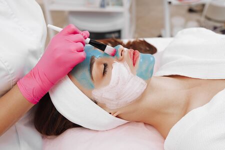 Spa Woman applying Facial cleansing Mask.の写真素材