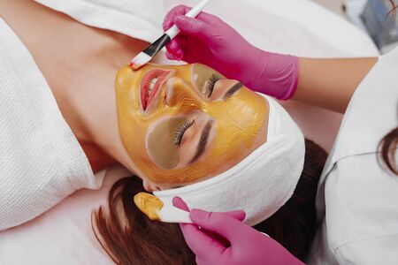 Spa Woman applying Facial cleansing Mask.の写真素材