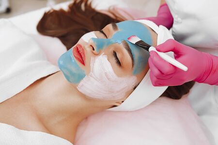 Spa Woman applying Facial cleansing Mask.の写真素材