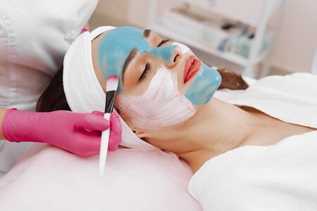 Spa Woman applying Facial cleansing Mask.の写真素材