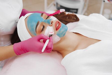 Spa Woman applying Facial cleansing Mask.の写真素材