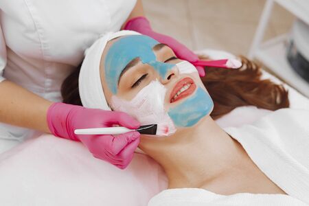 Spa Woman applying Facial cleansing Mask.の写真素材