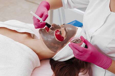Spa Woman applying Facial cleansing Mask.の写真素材
