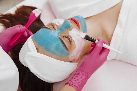 Spa Woman applying Facial cleansing Mask.の写真素材