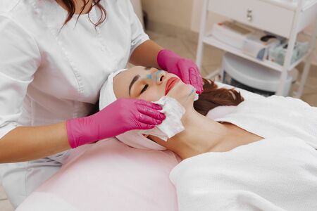 Spa Woman applying Facial cleansing Mask.の写真素材