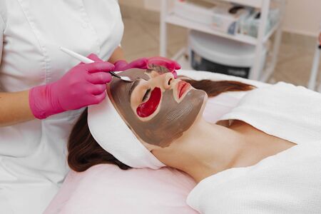 Spa Woman applying Facial cleansing Mask.の写真素材