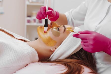 Spa Woman applying Facial cleansing Mask.の写真素材