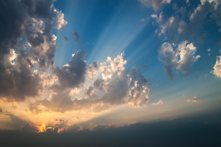 Inspiring sunset with dramatic sky, clouds and sunbeams 