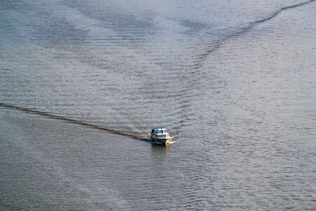Speed boat trail on a riverの写真素材
