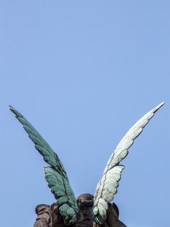 Big angel wings on a blue sky backgroundの写真素材