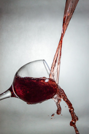 Interesting way for pouring and splashing wine in a glassの写真素材